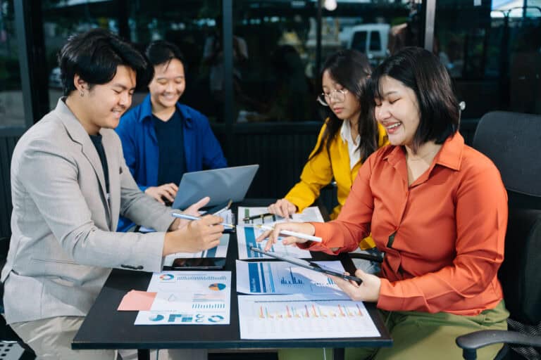 Business people making presentation with his colleagues and business smartphone, tablet digital computer as meeting concept at office